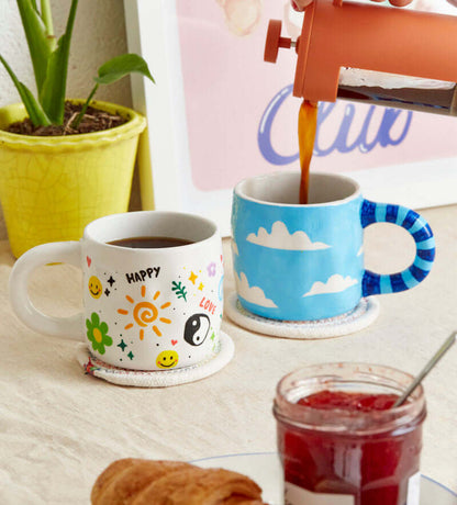 Hand-painted ceramic mug and decorative photo frame with a quick-start guide on a pink background, emphasizing creativity.